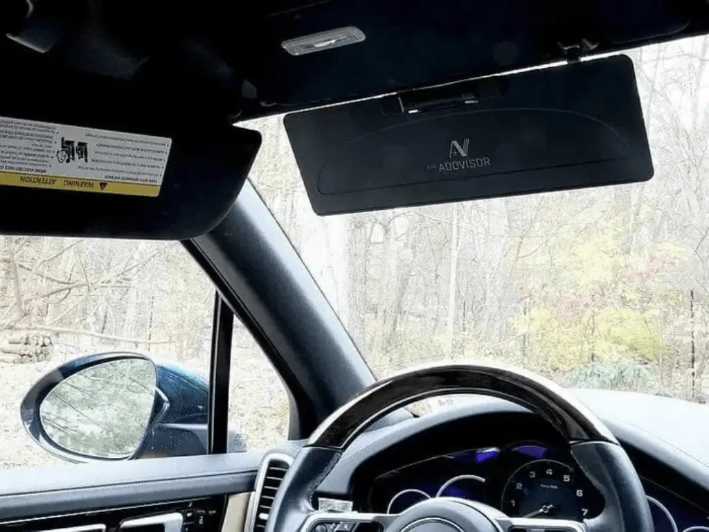 ADDVISOR installed on car sun visor in dark color variation reducing glare from front windshield and side