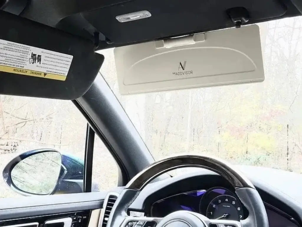 ADDVISOR installed on car sun visor in light color variation reducing glare from front windshield and side